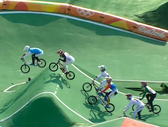 Full pack of BMX Olympians roll the berm jump in Rio